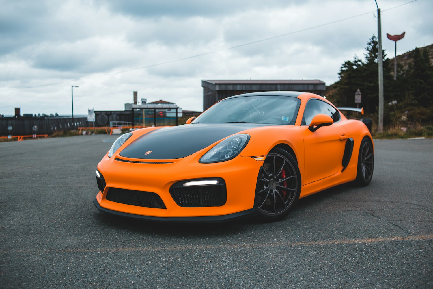Satin color-wrapped sports car photographed at a three-quarter front angle