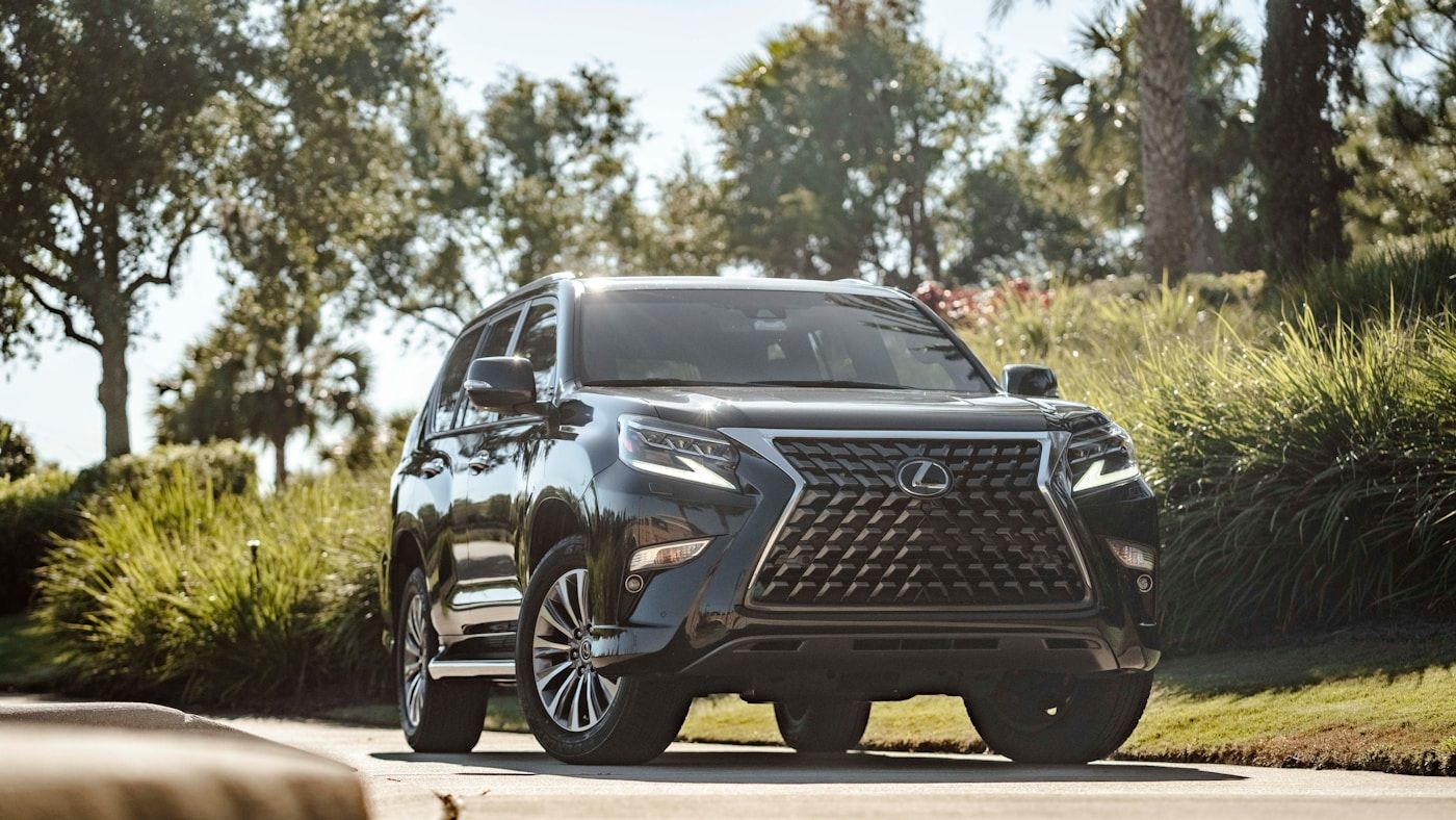 Black luxury SUV with dark ceramic tint across all glass including the windshield on a bright day