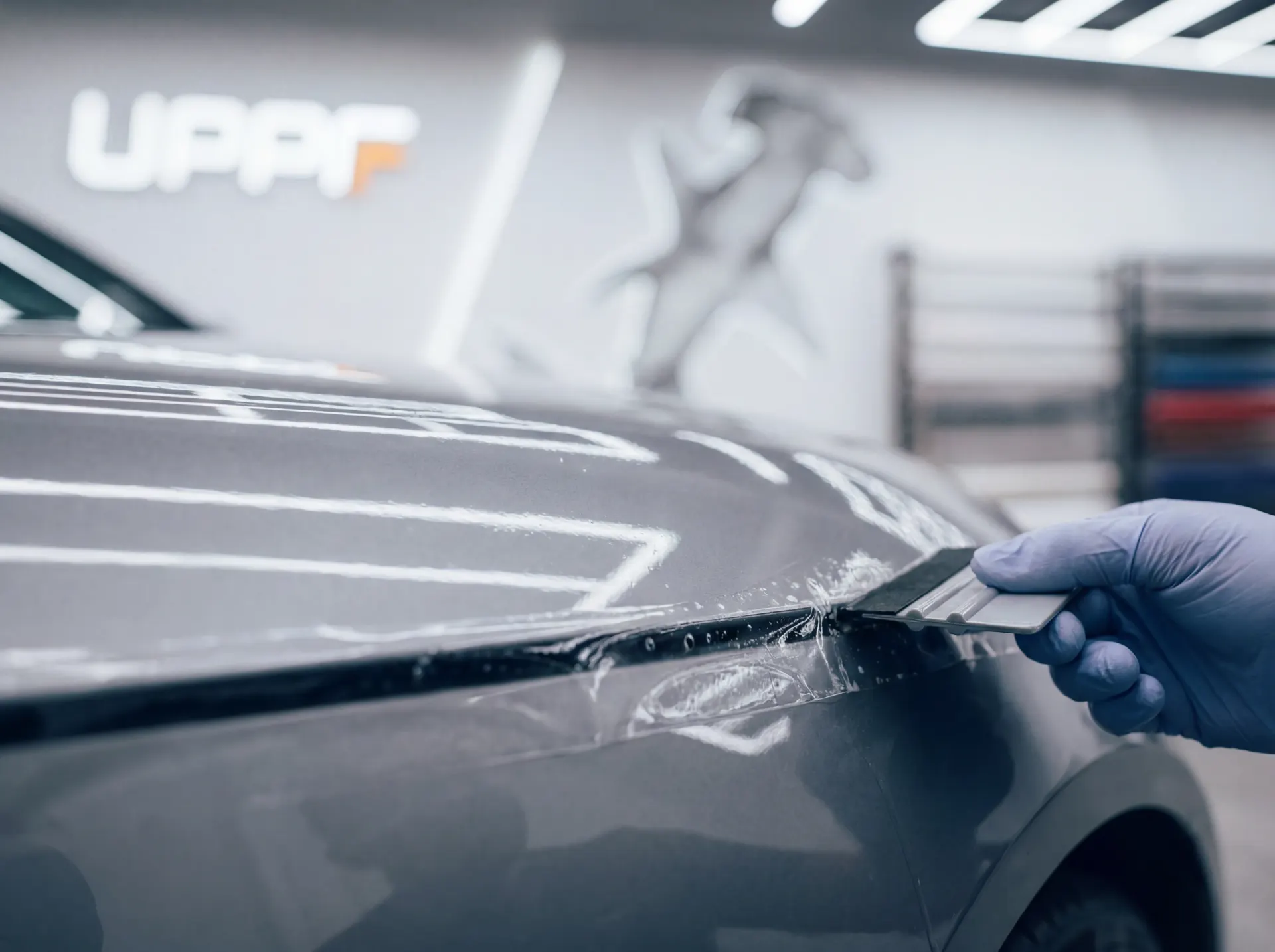 Certified technician installing clear paint protection film