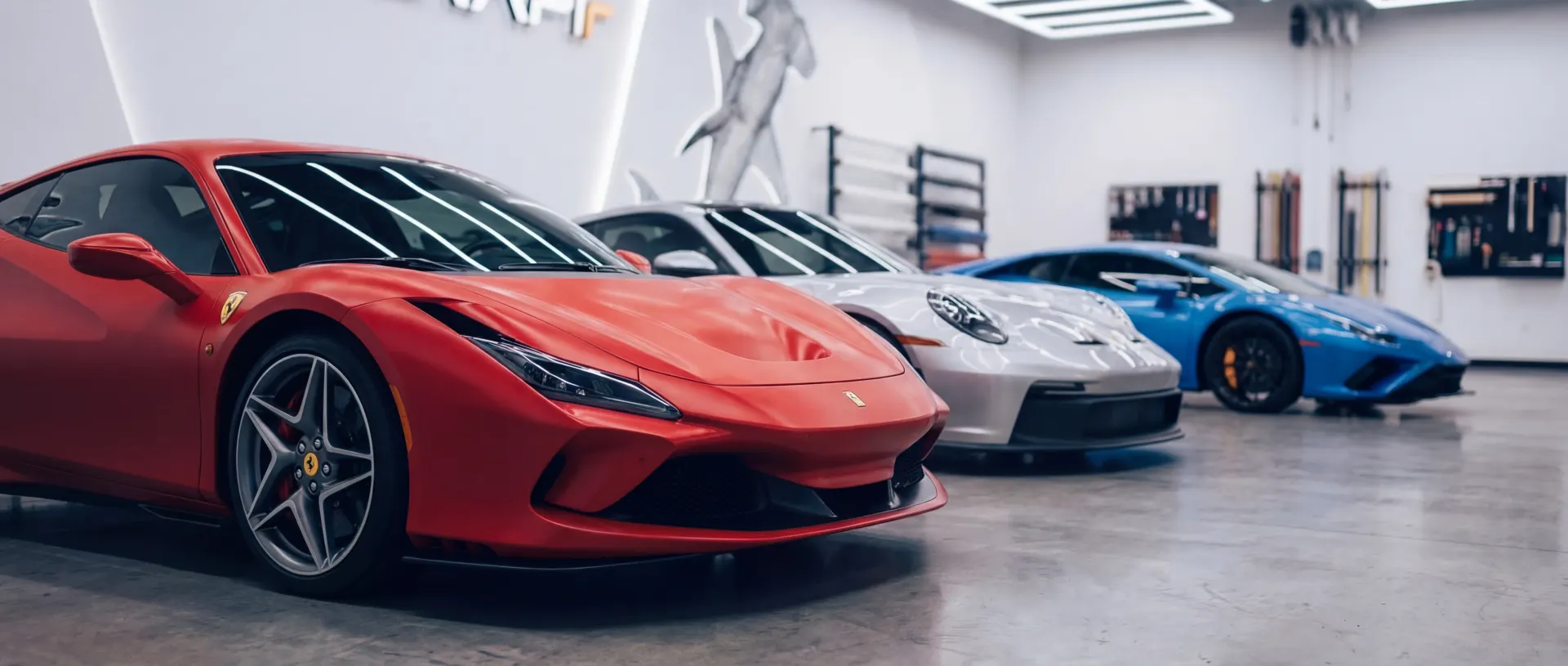 Luxury car with professional paint protection film installation in Houston automotive detailing studio showing transparent pricing